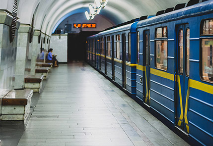 A blue metro train at an underground platform